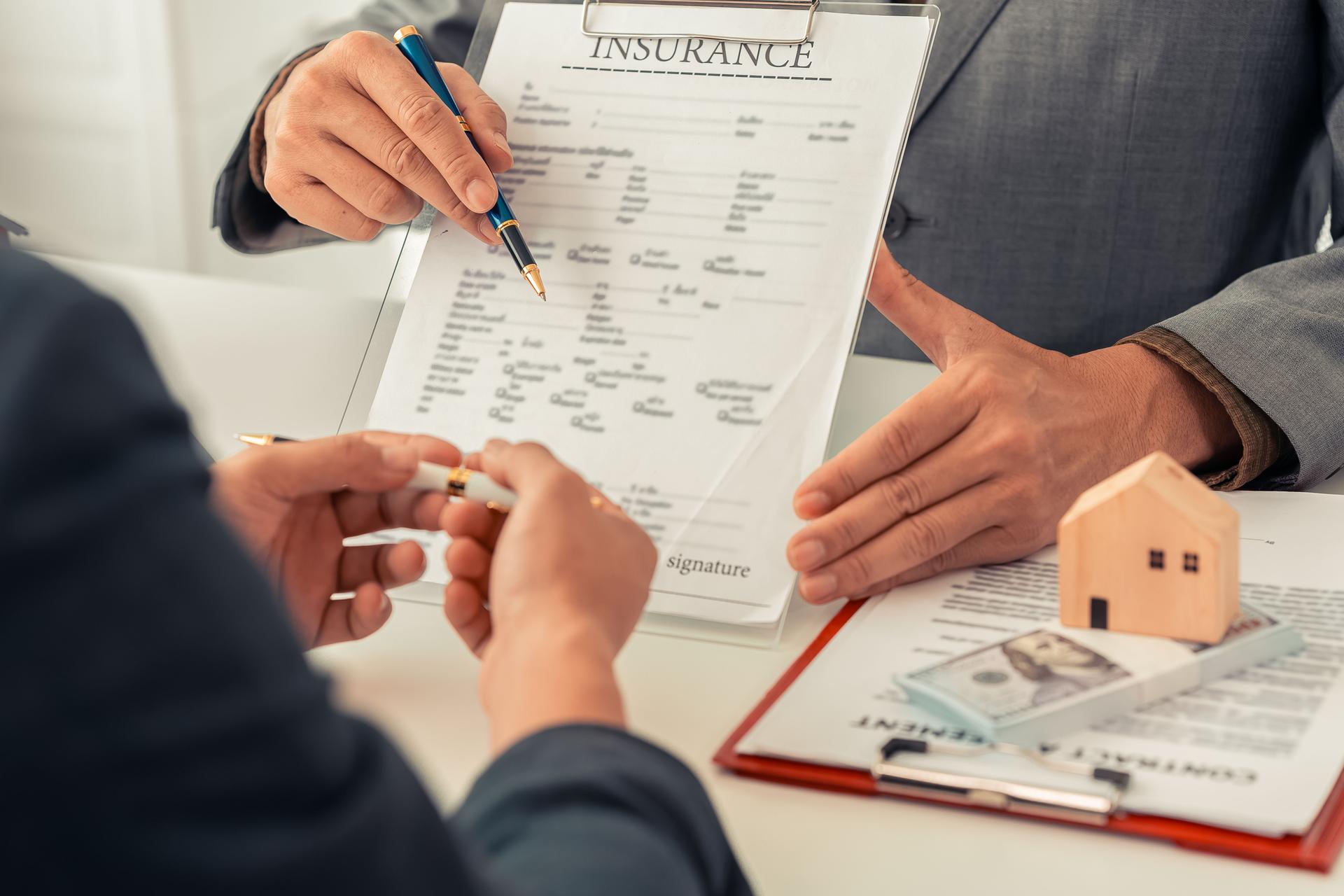 The real estate agent discussed the terms of the home purchase contract and asked the client to sign the document to legally complete the contract.